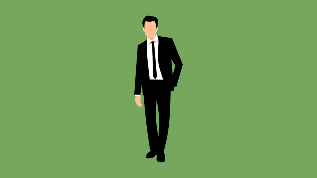 Businessman in suit on green background.