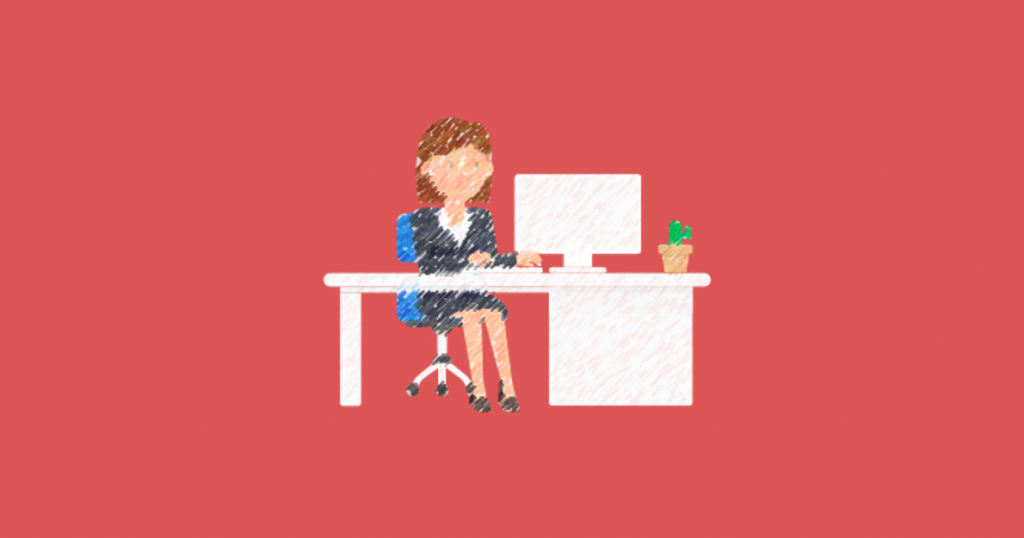 Corporate woman in suit sitting at computer, cactus also on desk